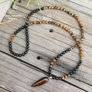 Collier "Absorption" en il de tigre et Onyx